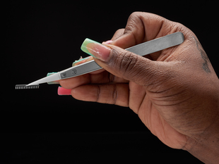 Lifestyle image showing tweezers picking up a microchip.