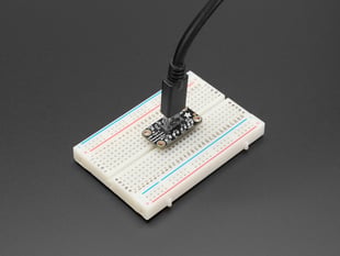 Angled shot of a long, rectangular USB-C assembled on a half-size breadboard with a USB-C cable.