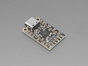 Angled shot of black, rectangular USB-to-serial breakout board.