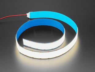 Semi-coiled one-meter long LED strip emitting neutral white light.
