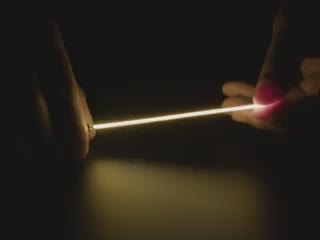 Video of Black hand articulating white LED filament.