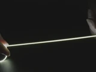 Video of Black hand articulating 300mm long white LED filament.