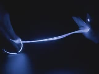 Video of Black hand articulating 300mm long blue LED filament.