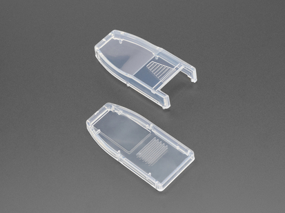 Angled shot of Two clear plastic enclosure pieces for a USB dongle.