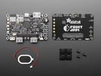 Kit contents including black, rectangular single board computer, small oval speaker, four rubber bumper feet, and hardware.