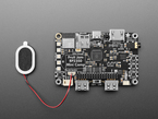 Black, rectangular single board computer with a small oval speaker.
