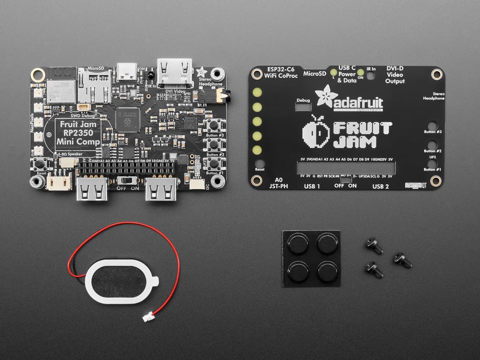 Kit contents including black, rectangular single board computer, small oval speaker, four rubber bumper feet, and hardware.
