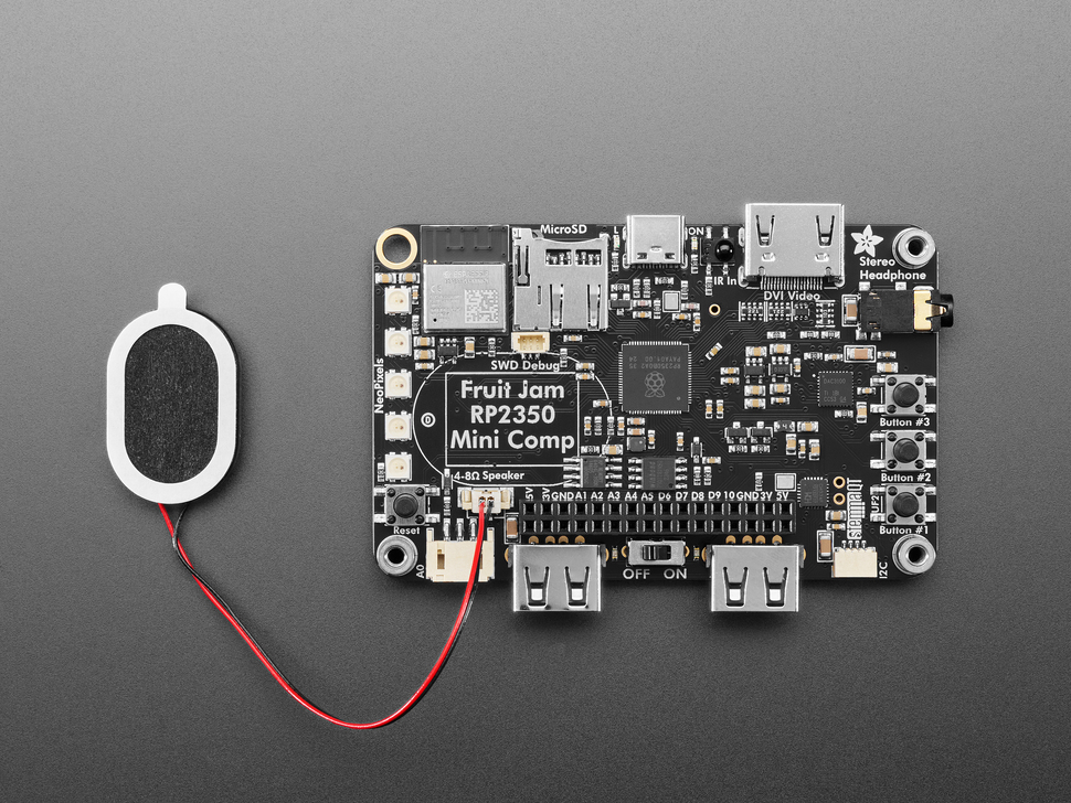 Black, rectangular single board computer with a small oval speaker.