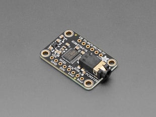 Angled shot of black, rectangular breakout board with audio jack