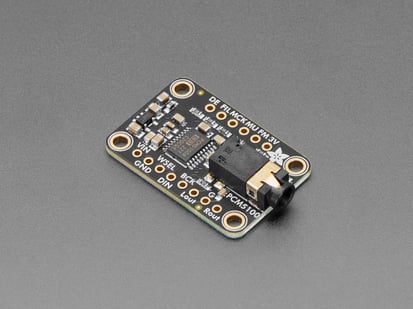 Angled shot of black, rectangular breakout board with audio jack