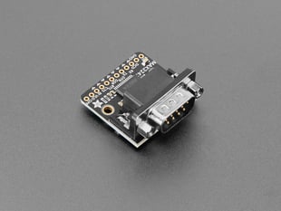 Angled shot of black, square-shaped DE9-M breakout board.