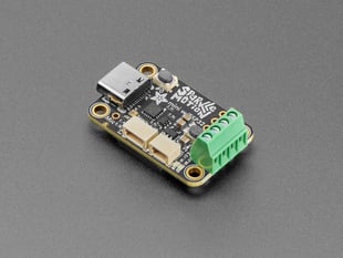 Angled shot of black, rectangular LED breakout PCB with USB-C and terminal blocks.