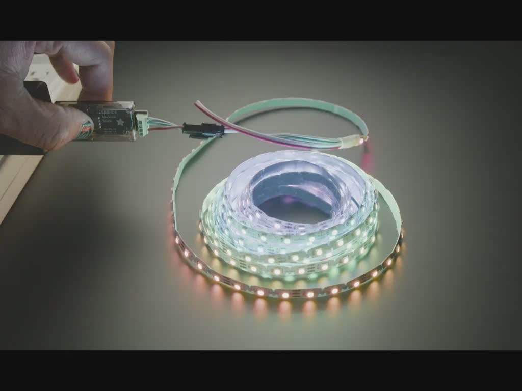 Video of a Black hand turning an LED reel on and off with a driver board.