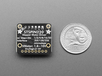 Top Down Bottom Shot of the Adafruit STSPIN220 Stepper Motor Driver Breakout Board next to a U.S. Quarter for Scale.