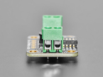 Close Up Shot of the green, two-pin terminal block on black, rectangular LED driver board.