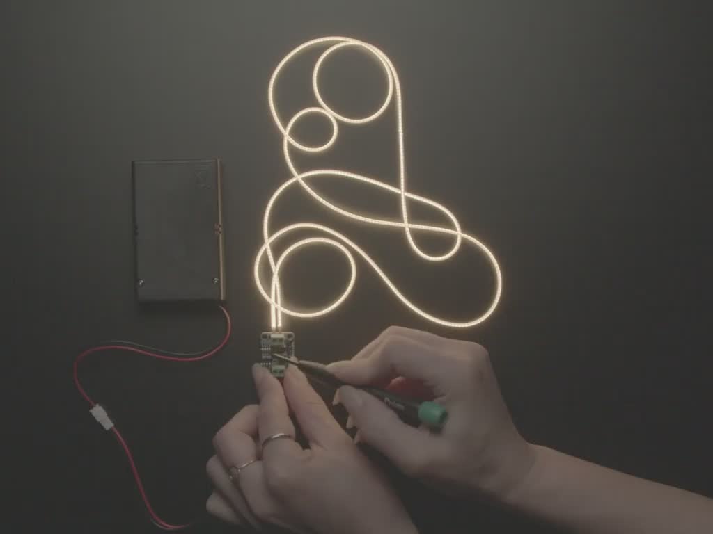 Demo video of a hand flipping switches on a boost converter board that makes the attached LED Filament get brighter with each switch change. The boost converter is connected to a battery pack.