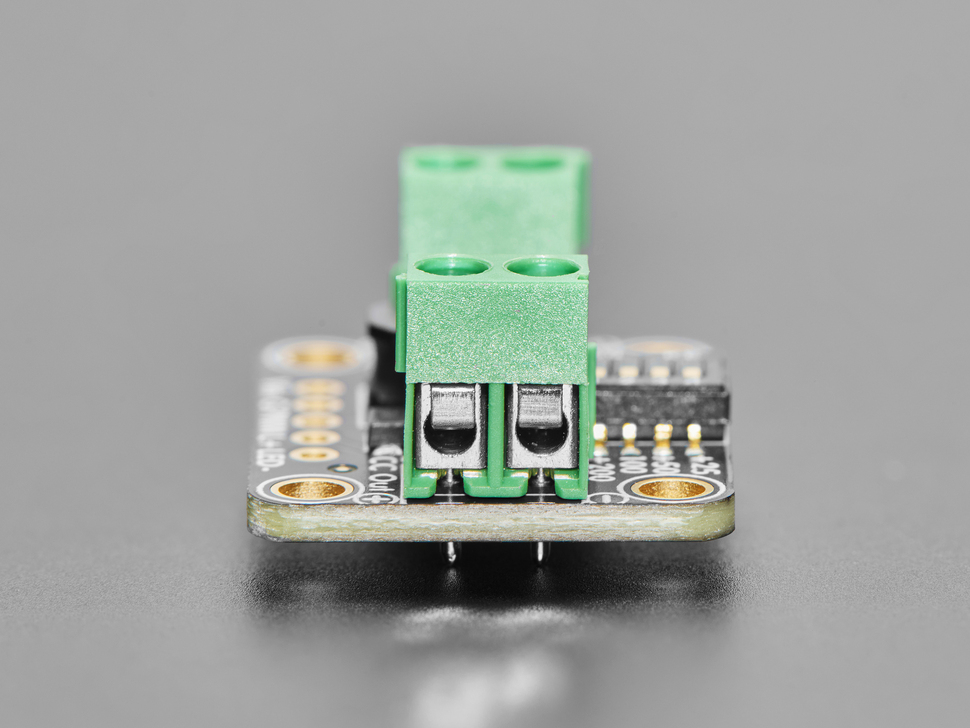 Close Up Shot of the green, two-pin terminal block on black, rectangular LED driver board.