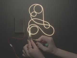 Demo video of a hand flipping switches on a boost converter board that makes the attached LED Filament get brighter with each switch change. The boost converter is connected to a battery pack.