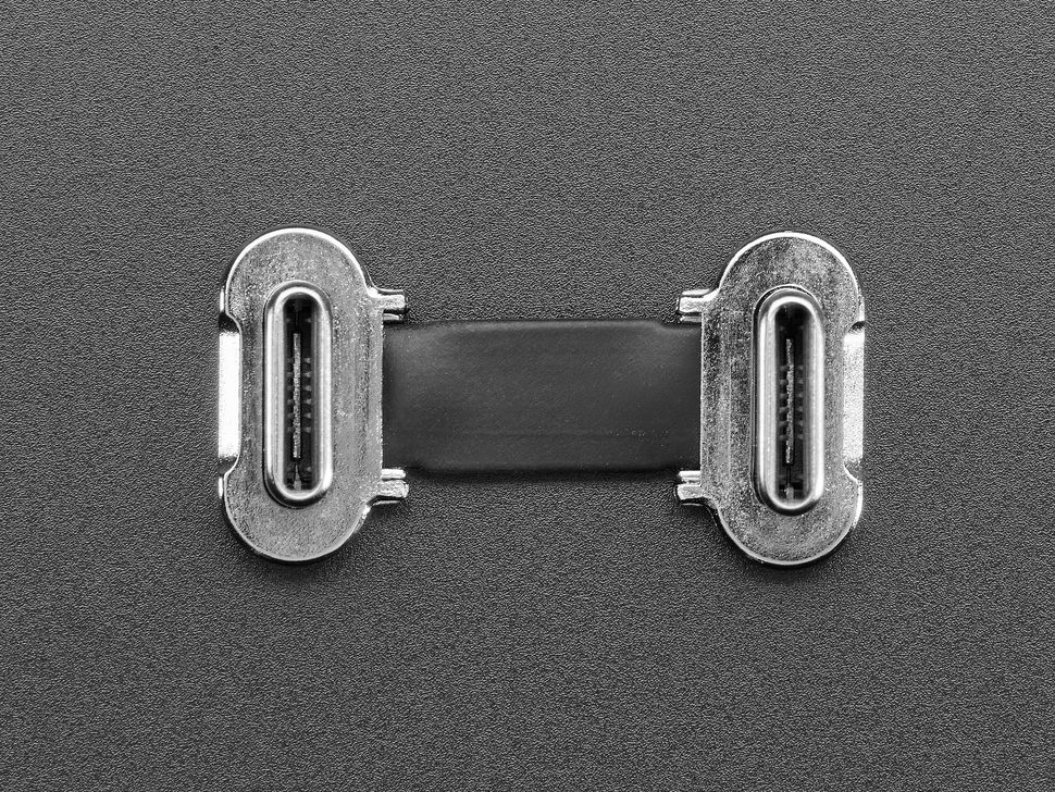 Overhead shot of a small, slim, 23mm long right angle USB C to USB C cable.