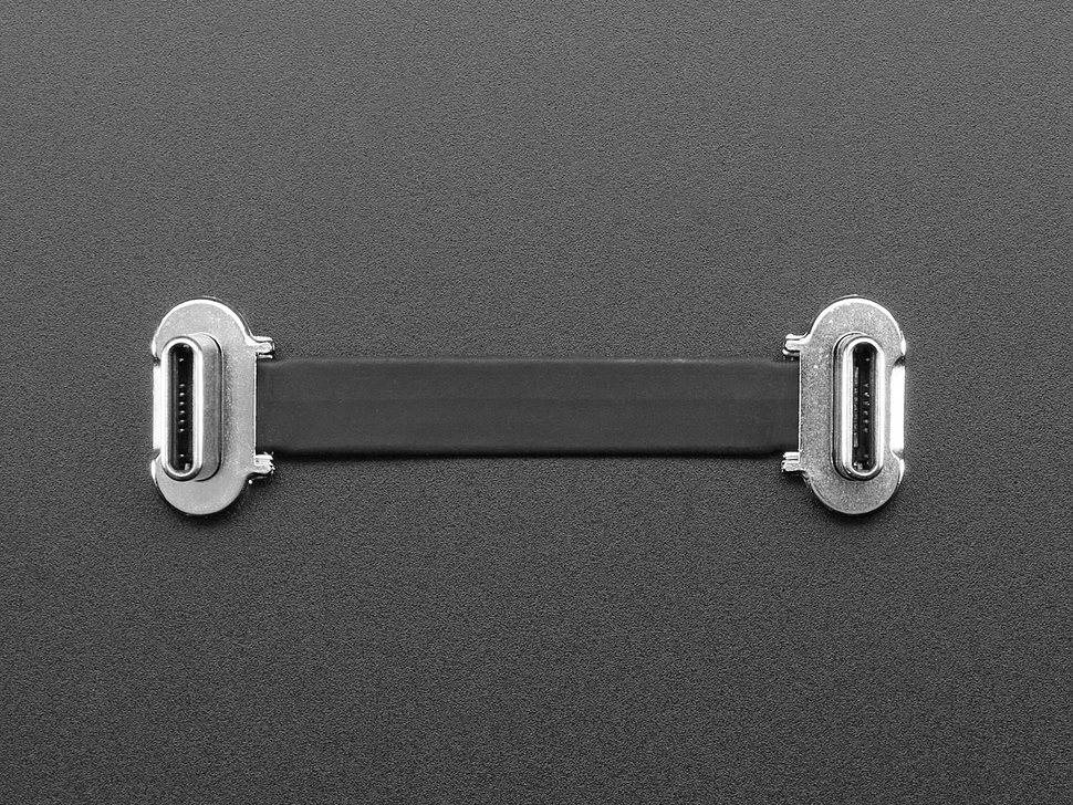 Overhead shot of a small, slim, 23mm long right angle USB C to USB C cable.
