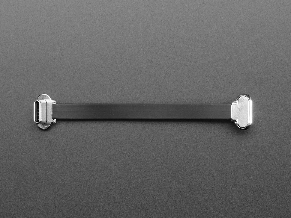 Overhead shot of a small, slim, 75mm long right angle USB C to USB C cable.