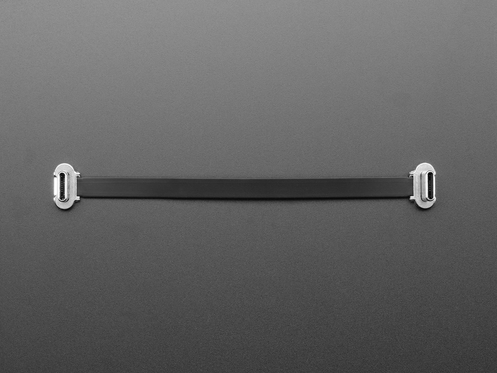 Overhead shot of a slim, 100mm long right angle USB C to USB C cable.