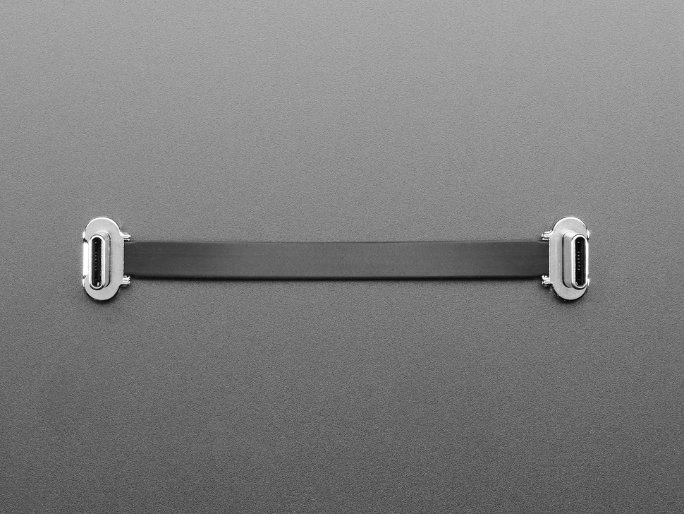 Overhead shot of a small, slim, 75mm long right angle USB C to USB C cable.