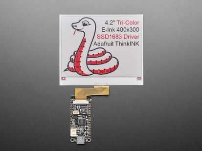 Angled shot of 4.2" tri-color electronic ink display showing a friendly python: "4.2" Tri-Color E-Ink 400x300 SSD1683 Driver Adafruit ThinkInk"
