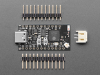 small, black, rectangle-shaped microcontroller with two sticks of header and a 2-pin JST-PH connector.