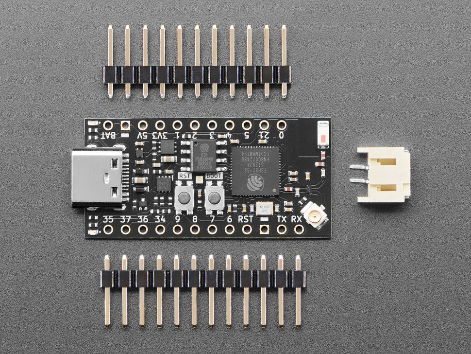 small, black, rectangle-shaped microcontroller with two sticks of header and a 2-pin JST-PH connector.