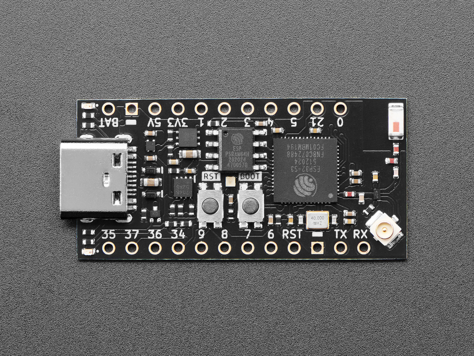 Overhead shot of small, black, rectangle-shaped microcontroller.
