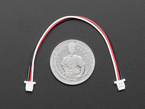 Top Down Shot of the JST SH Compatible 1mm Pitch 3-pin Plug-Plug Cable next to a U.S. Quarter for Scale.