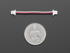50mm long JST-SH 1mm pitch 3-pin cable with plug connectors above a U.S. quarter for scale.