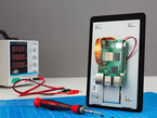 Lifestyle image of 5 inch touch screen with oscilloscope, screwdriver, and workspace.