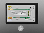Back of 7 inch touchscreen display with U.S. quarter for scale.