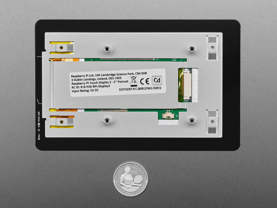 Back of 7 inch touchscreen display with U.S. quarter for scale.