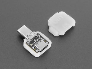 Angled shot of two pieces of white plastic square-shaped enclosure pieces. A USB-C breakout PCB is enclosed.