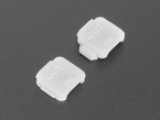 Angled shot of two pieces of white plastic square-shaped enclosure pieces.