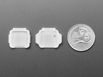 Two pieces of white plastic square-shaped enclosure pieces with U.S. quarter for scale.