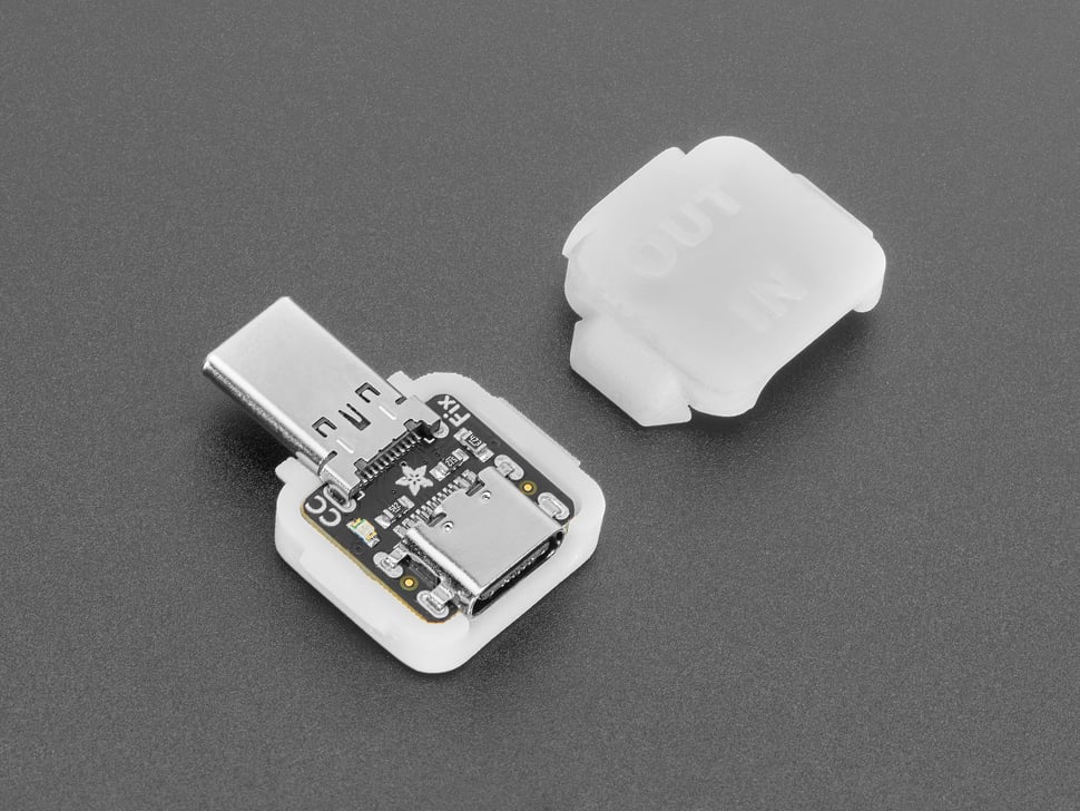 Angled shot of two pieces of white plastic square-shaped enclosure pieces. A USB-C breakout PCB is enclosed.