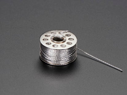 Small spool of conductive thread.