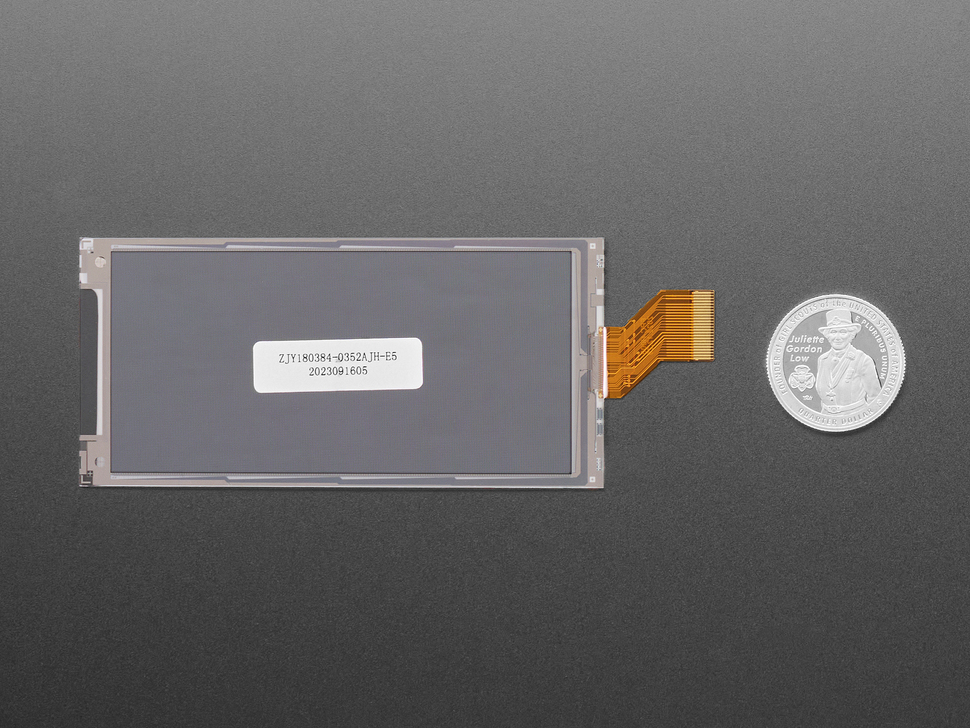 Back of 3.52" electronic ink display module with U.S. quarter for scale.