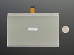 Back of 7.5" electronic ink display module with U.S. quarter for scale.