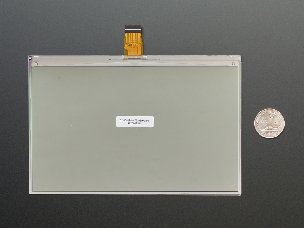 Back of 7.5" electronic ink display module with U.S. quarter for scale.