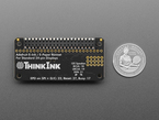 Back of black, rectangle-shaped PCB with U.S. quarter for scale.