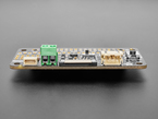 Side shot highlighting green, 2-pin terminal block and 2-pin JST-PH connector on PCB.