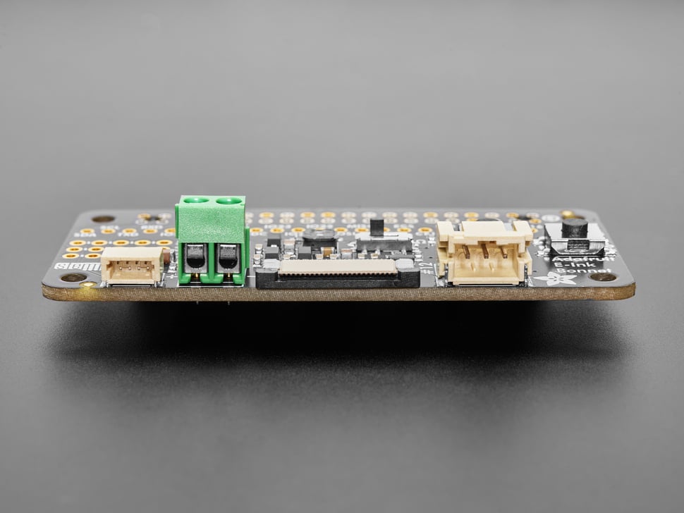 Side shot highlighting green, 2-pin terminal block and 2-pin JST-PH connector on PCB.