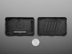 Top Down Shot of the Interior Side to the top and bottom of the Snap-on Enclosure next to a U.S. Quarter for Scale.