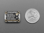 Top Down Back Shot of the Adafruit STHS34PF80 IR Presence / Motion Sensor - STEMMA QT / Qwiic next to a U.S. Quarter for Scale.