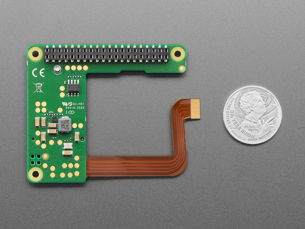 Top Down Bottom Shot of the Raspberry Pi M.2 HAT+ Compact next to a U.S. Quarter for Scale.